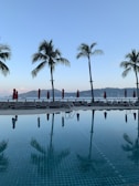 Sunlit view of the private saltwater pool with lounge chairs and desert mountains in the background.
