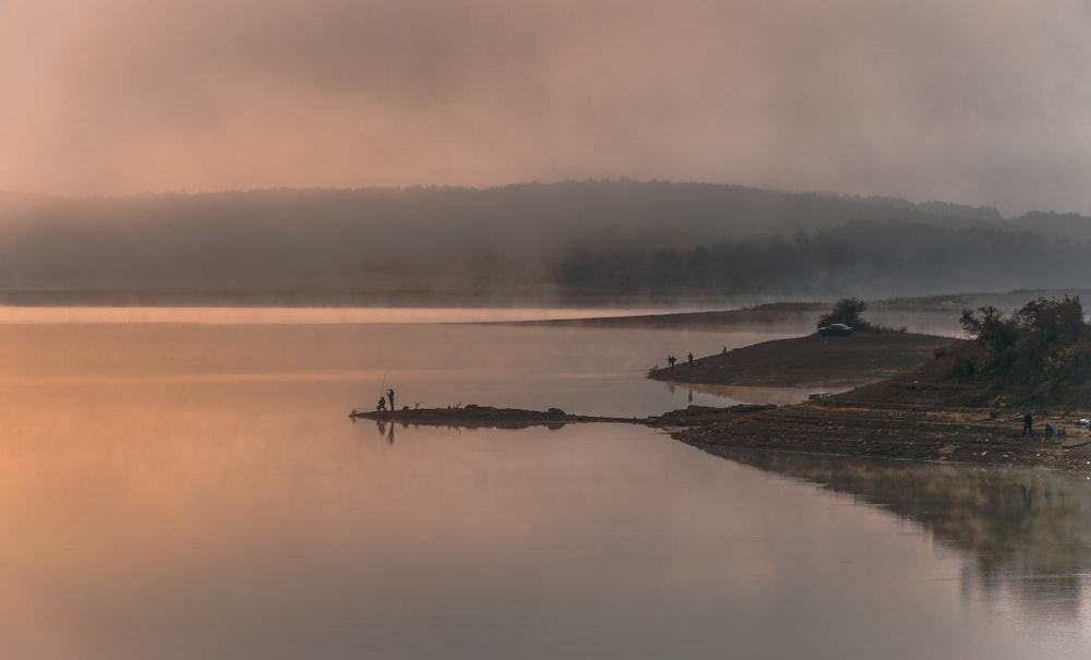 silhouette of people riding on boat on body of water during daytime