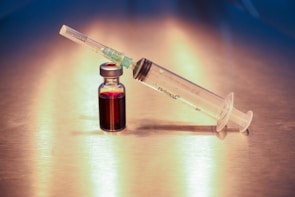 Close-up of a vial labeled trazepatide with a syringe ready for injection.