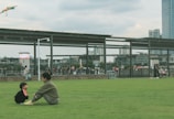 A social worker engaging with families in a park.