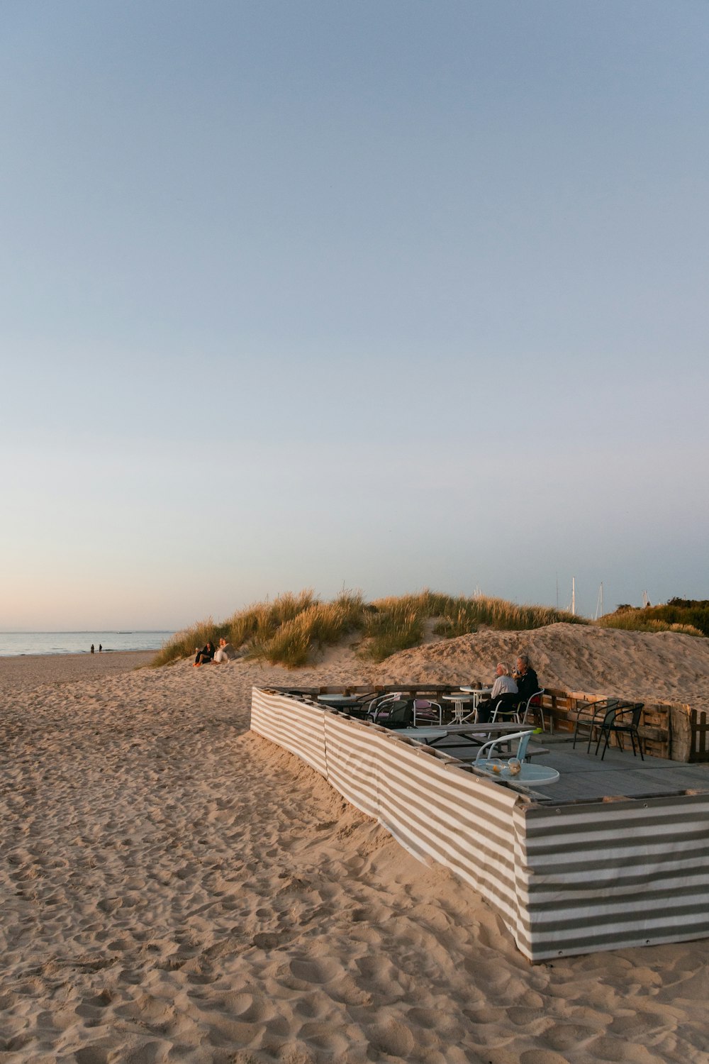 white wooden lounge chairs on beach during daytime