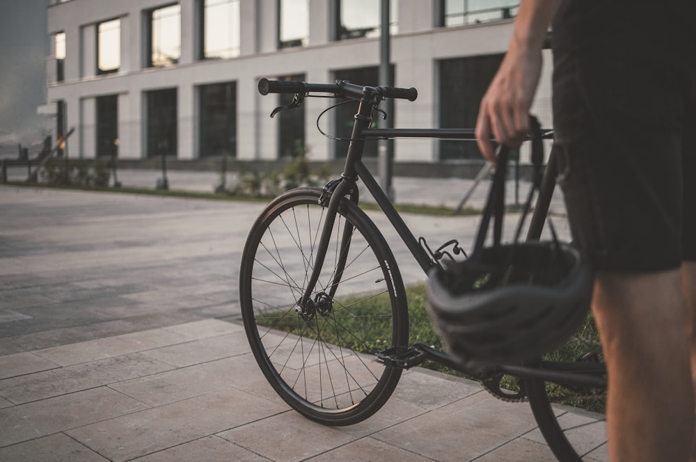 black city bicycle on brown concrete floor