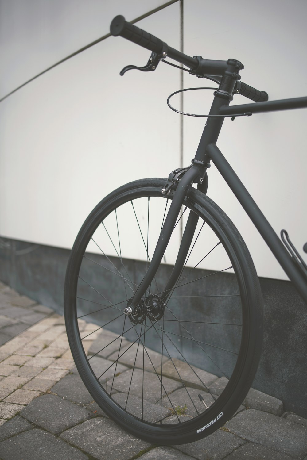 black bicycle on brown brick floor