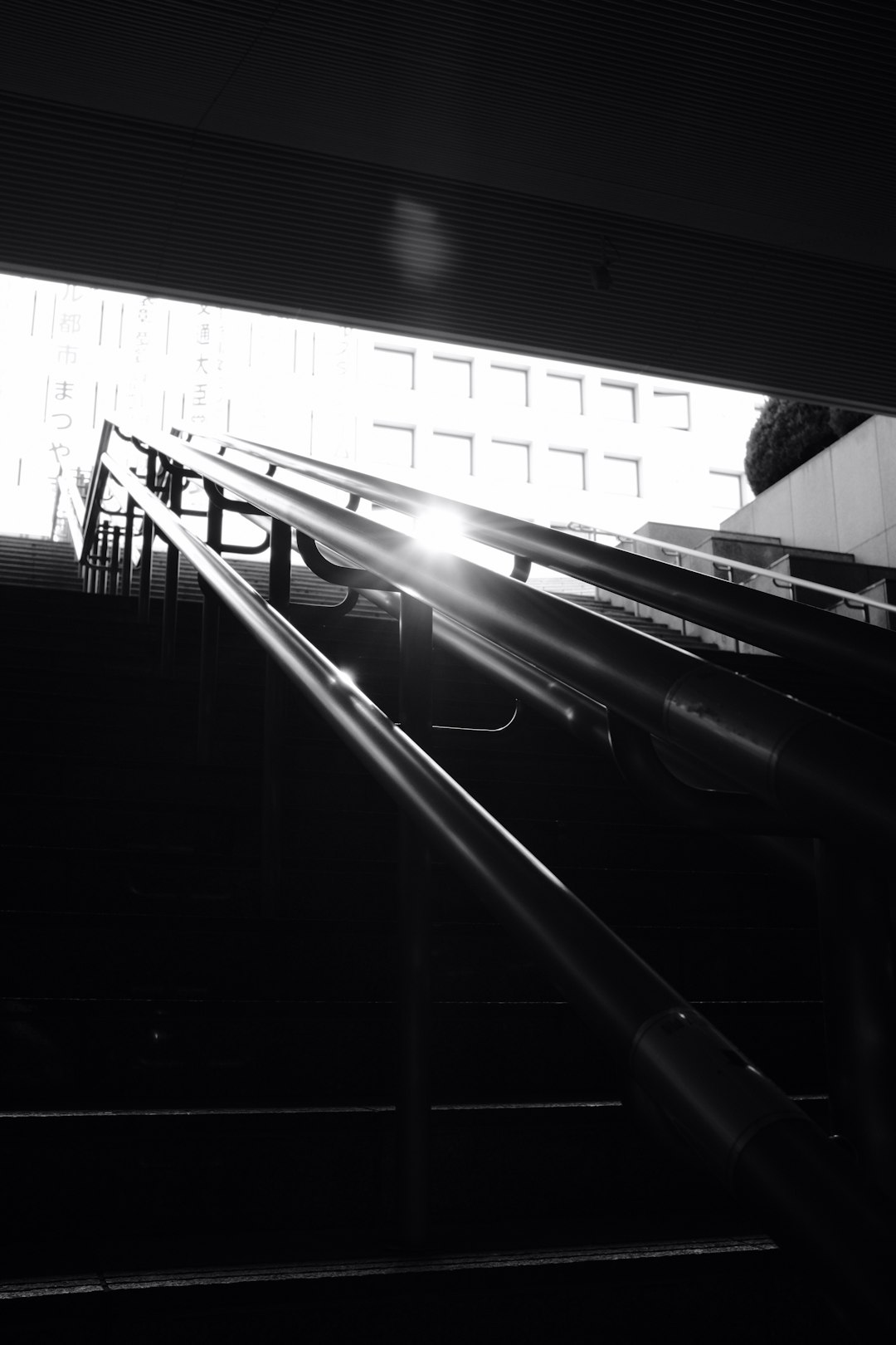 grayscale photo of a escalator