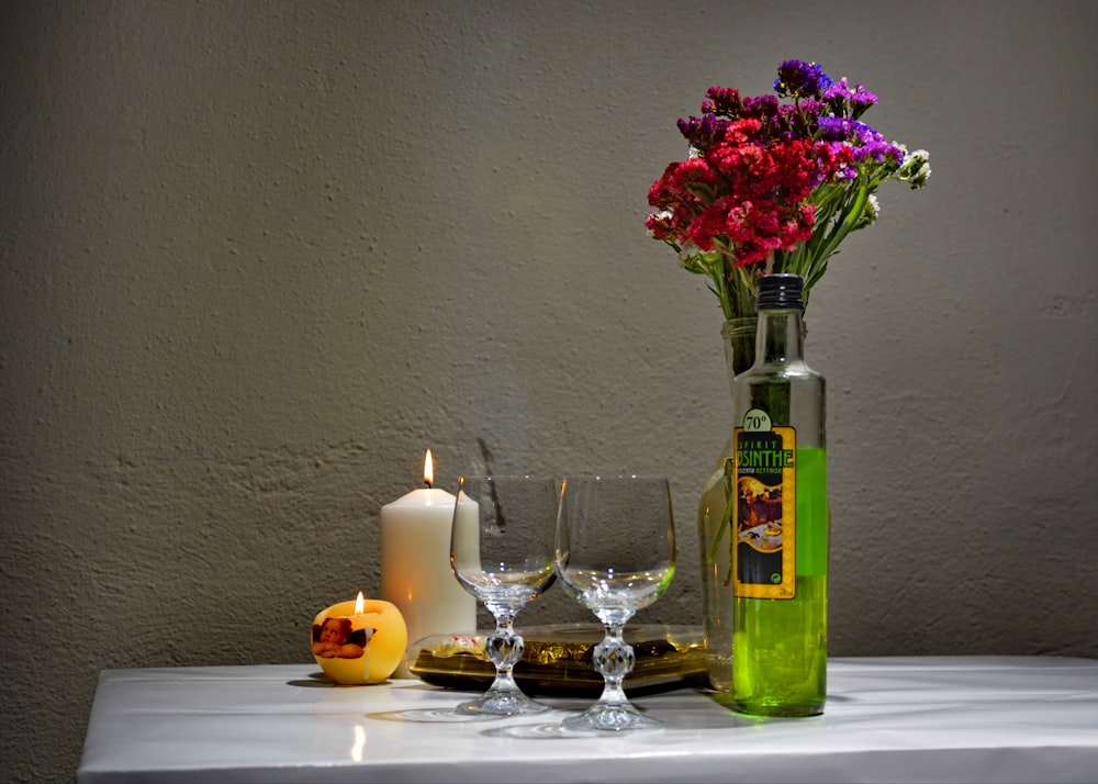 red roses in green glass vase