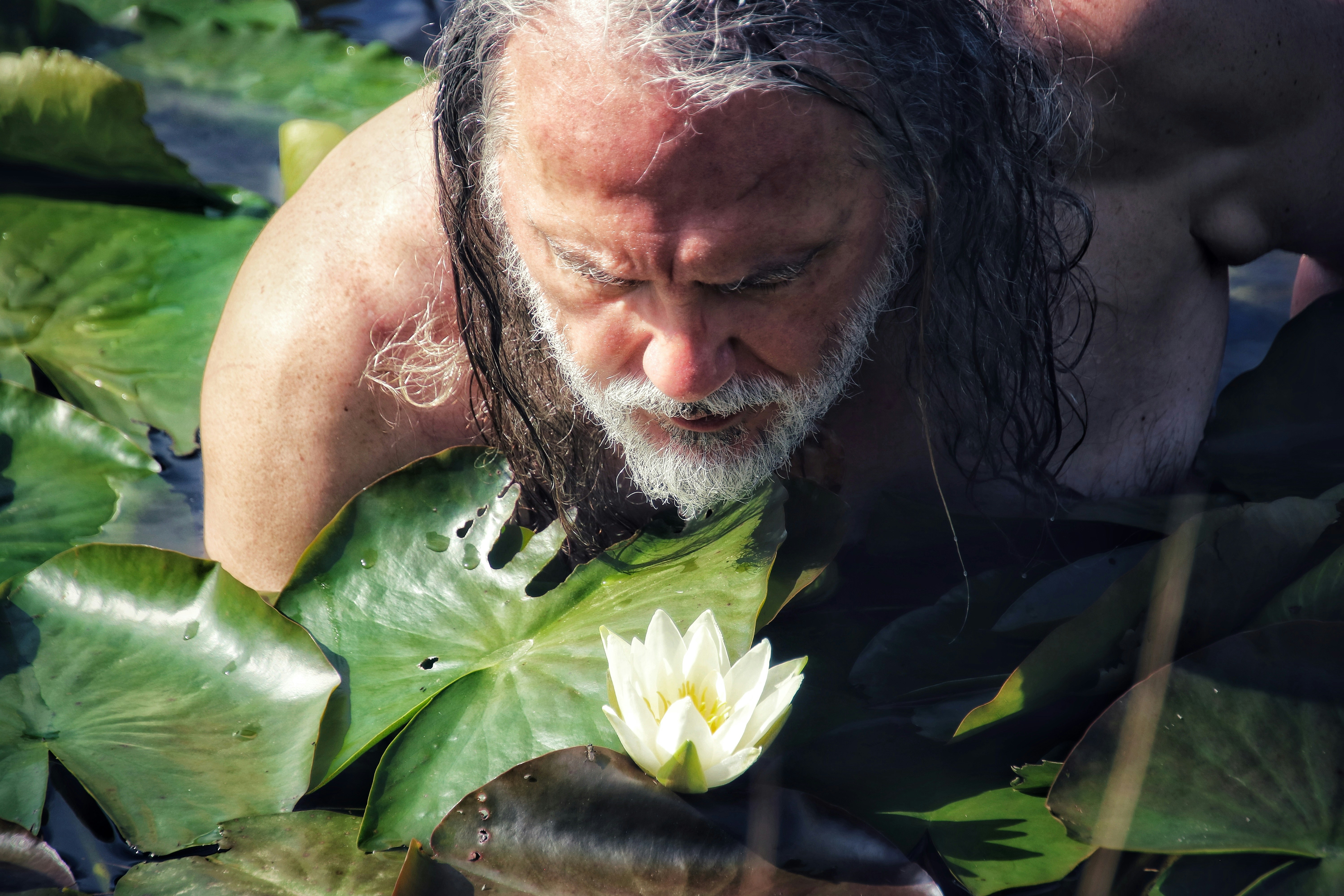 man with green leaves on his head