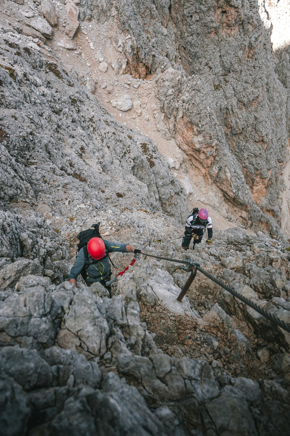 man in black jacket and black pants climbing on ladder