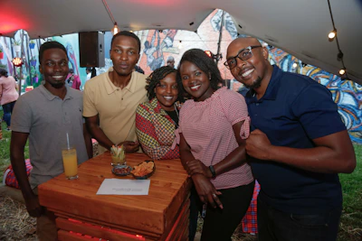 A lively group of five sharing laughs and tasting dishes in a hidden Damascus alley.