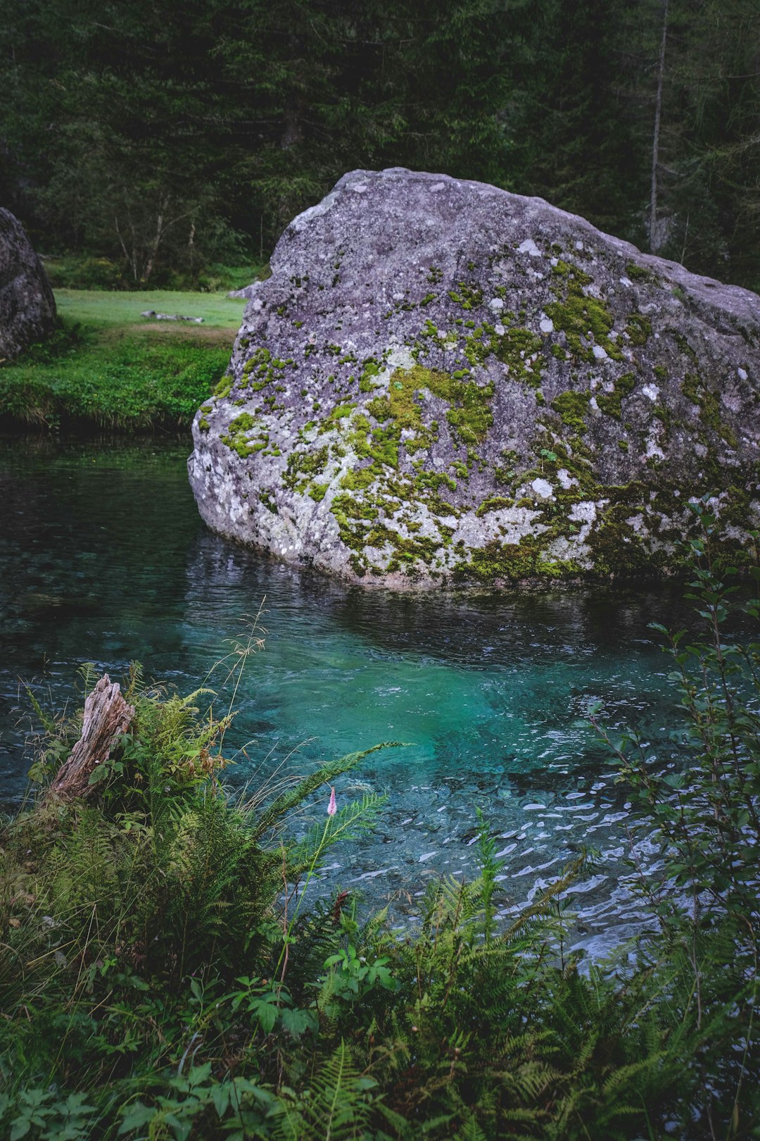 body of water near gray rock