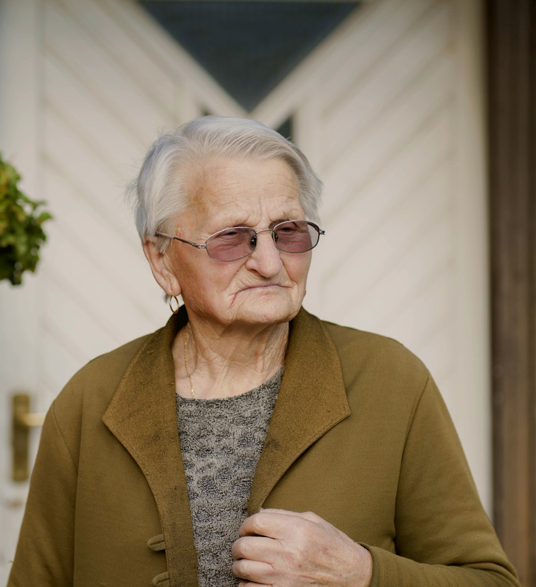 woman in brown coat wearing eyeglasses