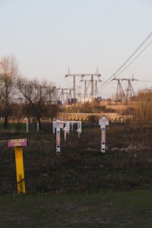 An industrial site with high voltage power lines in the background.