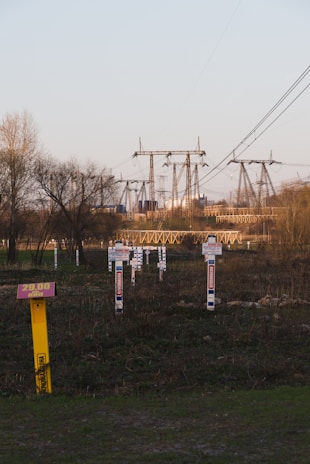An industrial site with high-voltage power lines in the background.