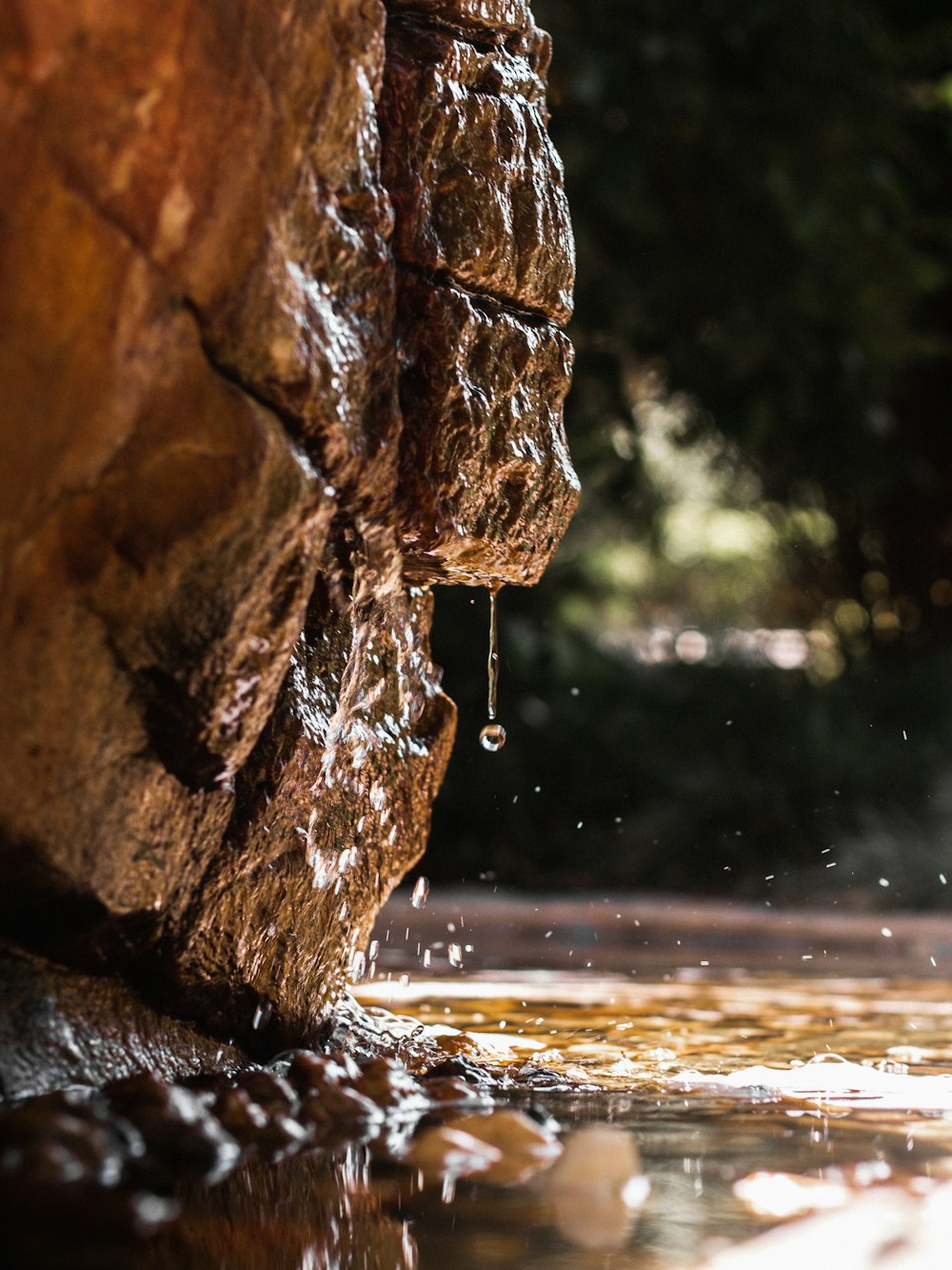 water falling from brown rock