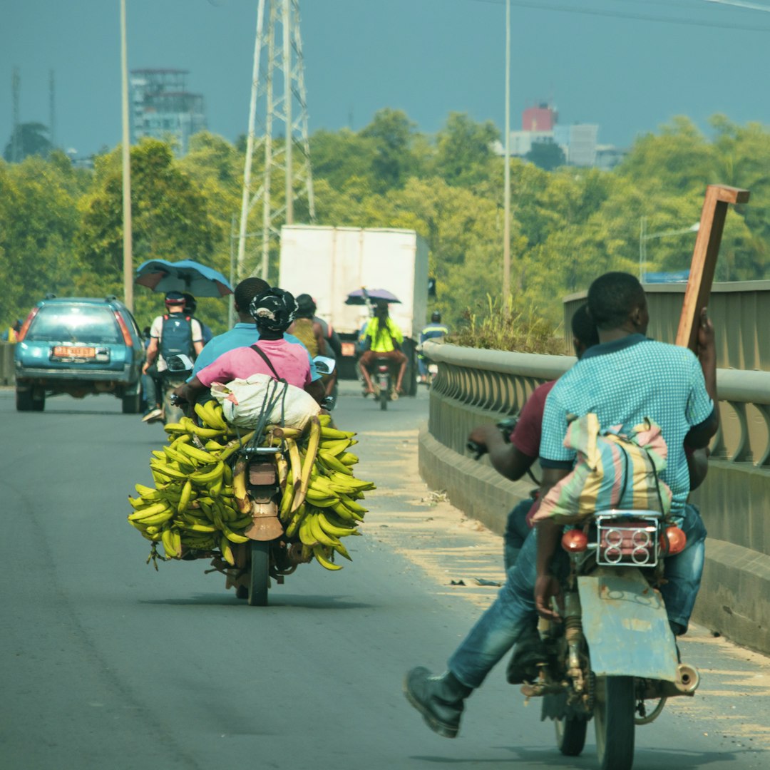 people riding motorcycle on road during daytime