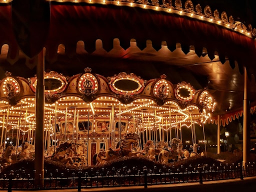 brown wooden carousel with lights turned on during night time