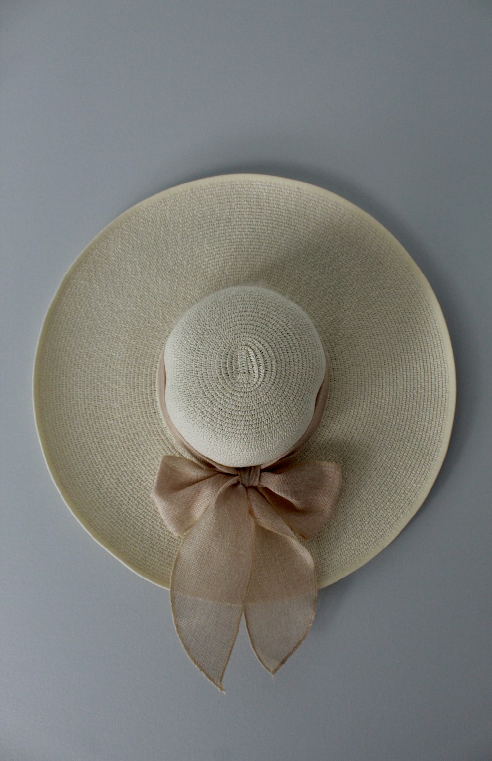 beige hat on white surface