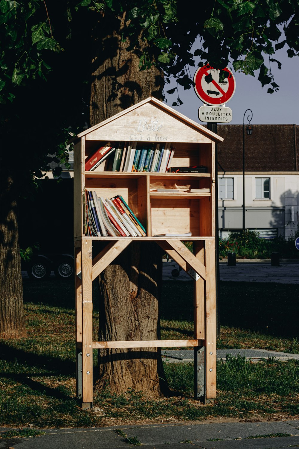 brown wooden shelf with books