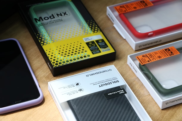 Close-up of colorful smartphone cases neatly arranged on a wooden table.