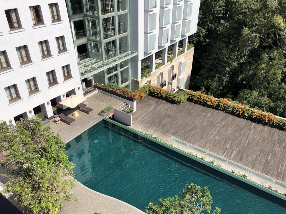 white and brown concrete building near swimming pool during daytime