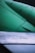 Close-up view of an aircraft wing displaying metal rivets and panels. The text 'NO STEP' is clearly visible on one section of the surface. The upper part of the image shows a green-colored aircraft engine or structure.