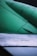 Close-up view of an aircraft wing displaying metal rivets and panels. The text 'NO STEP' is clearly visible on one section of the surface. The upper part of the image shows a green-colored aircraft engine or structure.