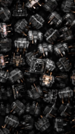 A close-up of a mechanical keyboard showing individual switches under the keycaps