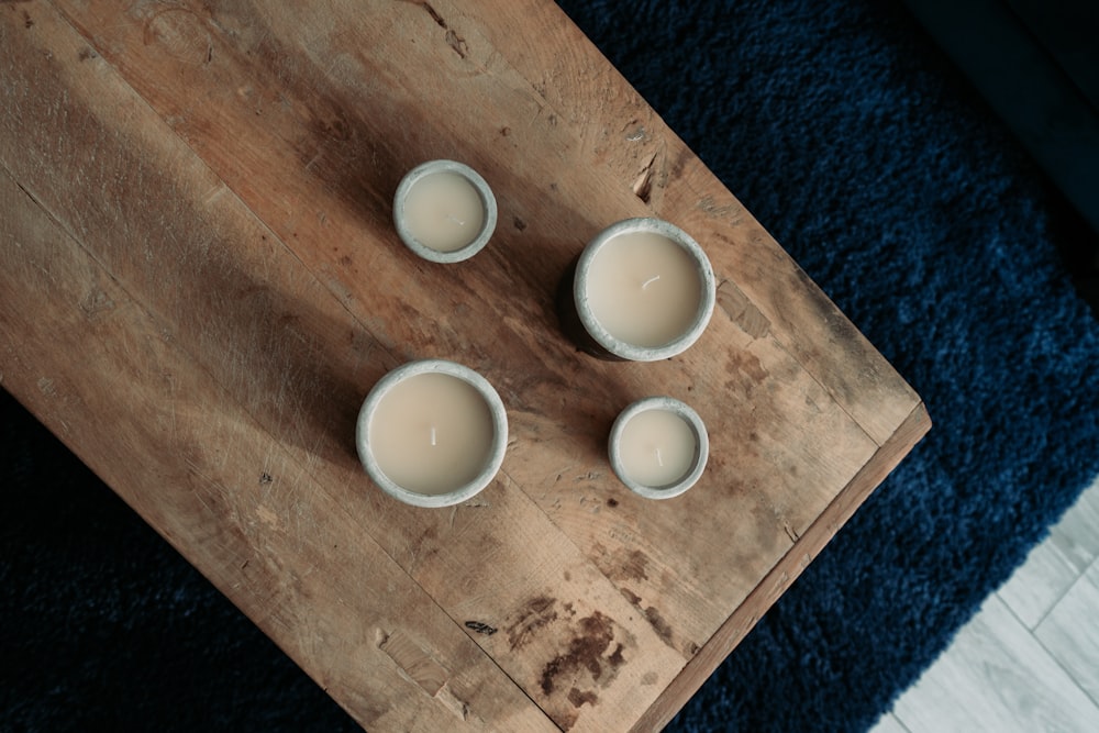 white ceramic bowls on brown wooden table