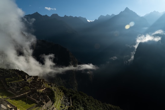 A breathtaking sunrise view over the ancient Machu Picchu ruins surrounded by lush green mountains.