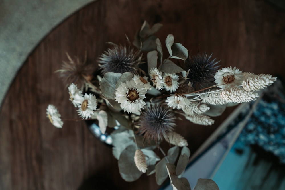 white and brown flowers on brown wooden table