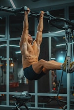 topless man in black shorts doing exercise