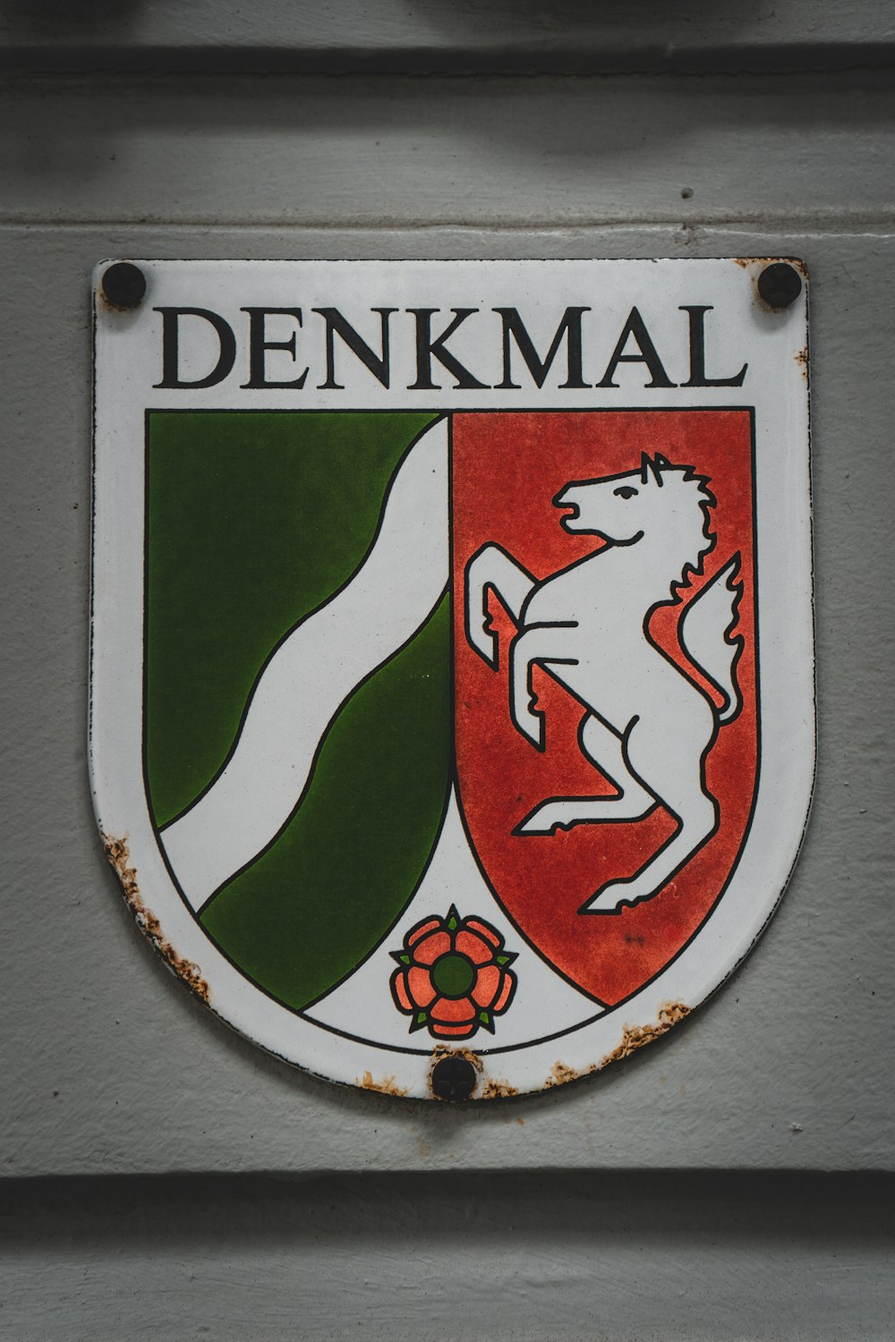 a sign on the side of a building that says denkmal