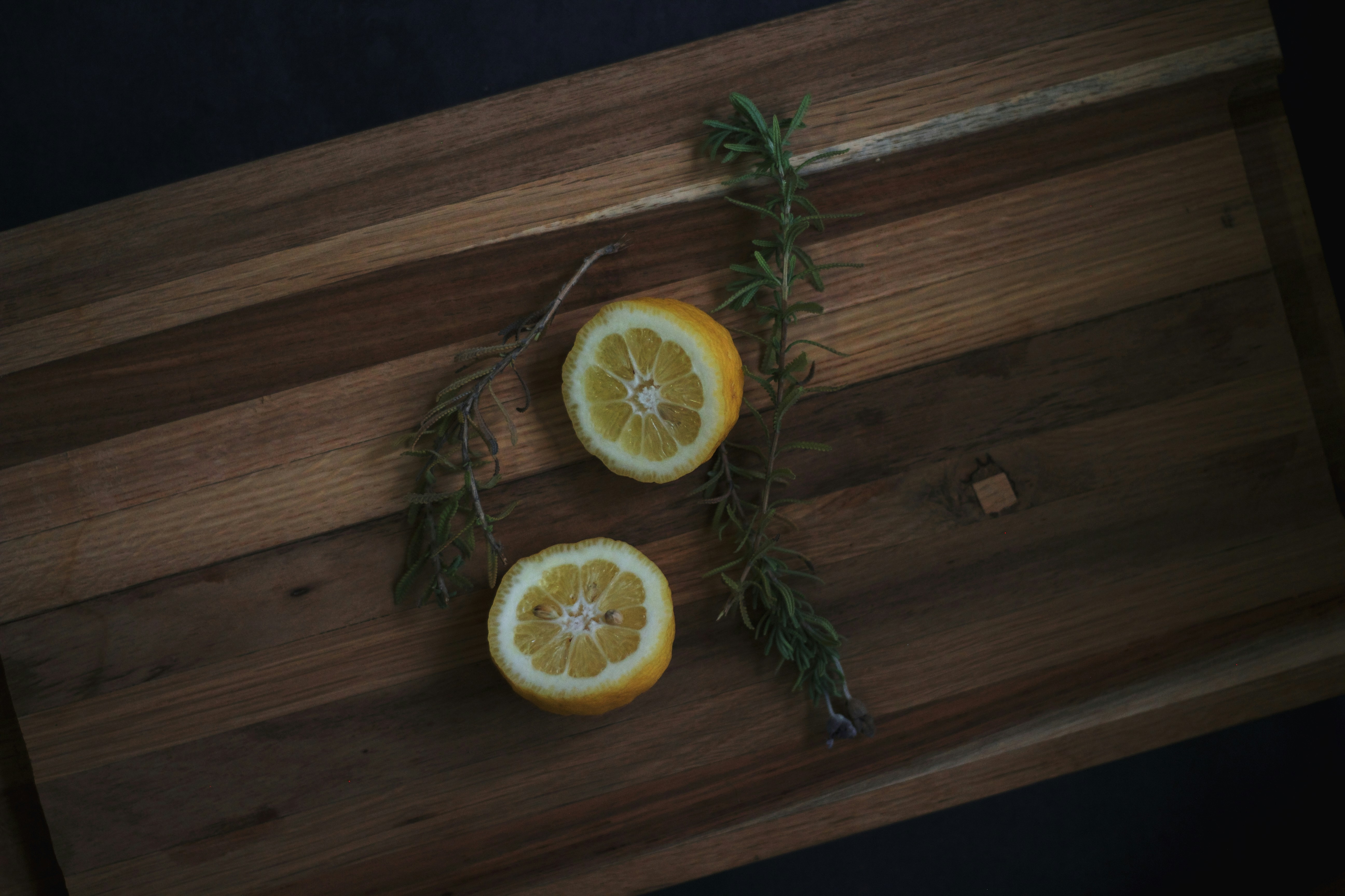 sliced orange fruit on brown wooden table