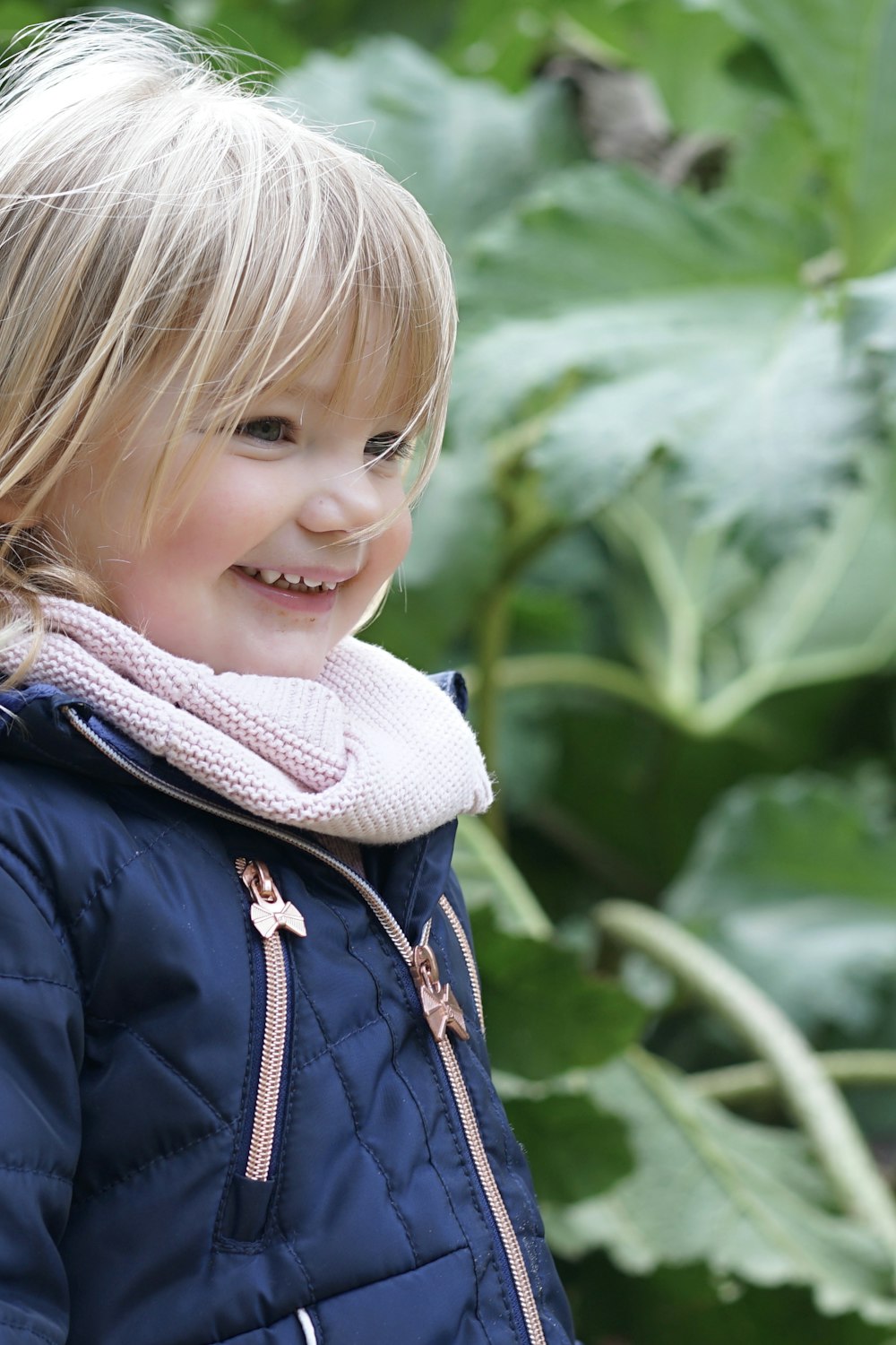 girl in white knit scarf and blue jacket