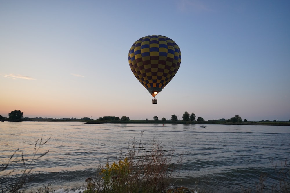 hot air balloon flying over the sea during daytime