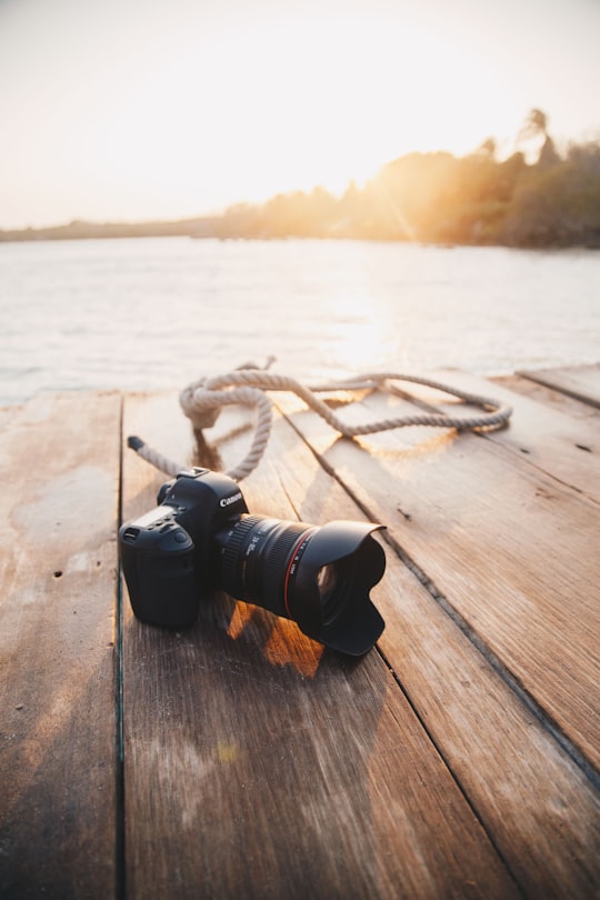 black dslr camera on brown wooden dock in Cartagena Colombia