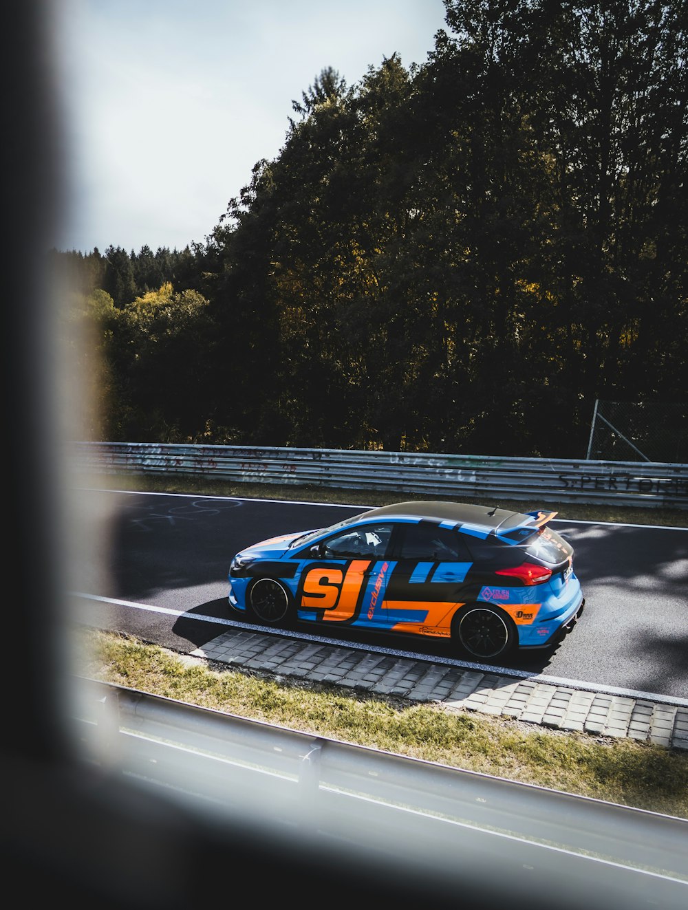 blue and white porsche 911 on road during daytime