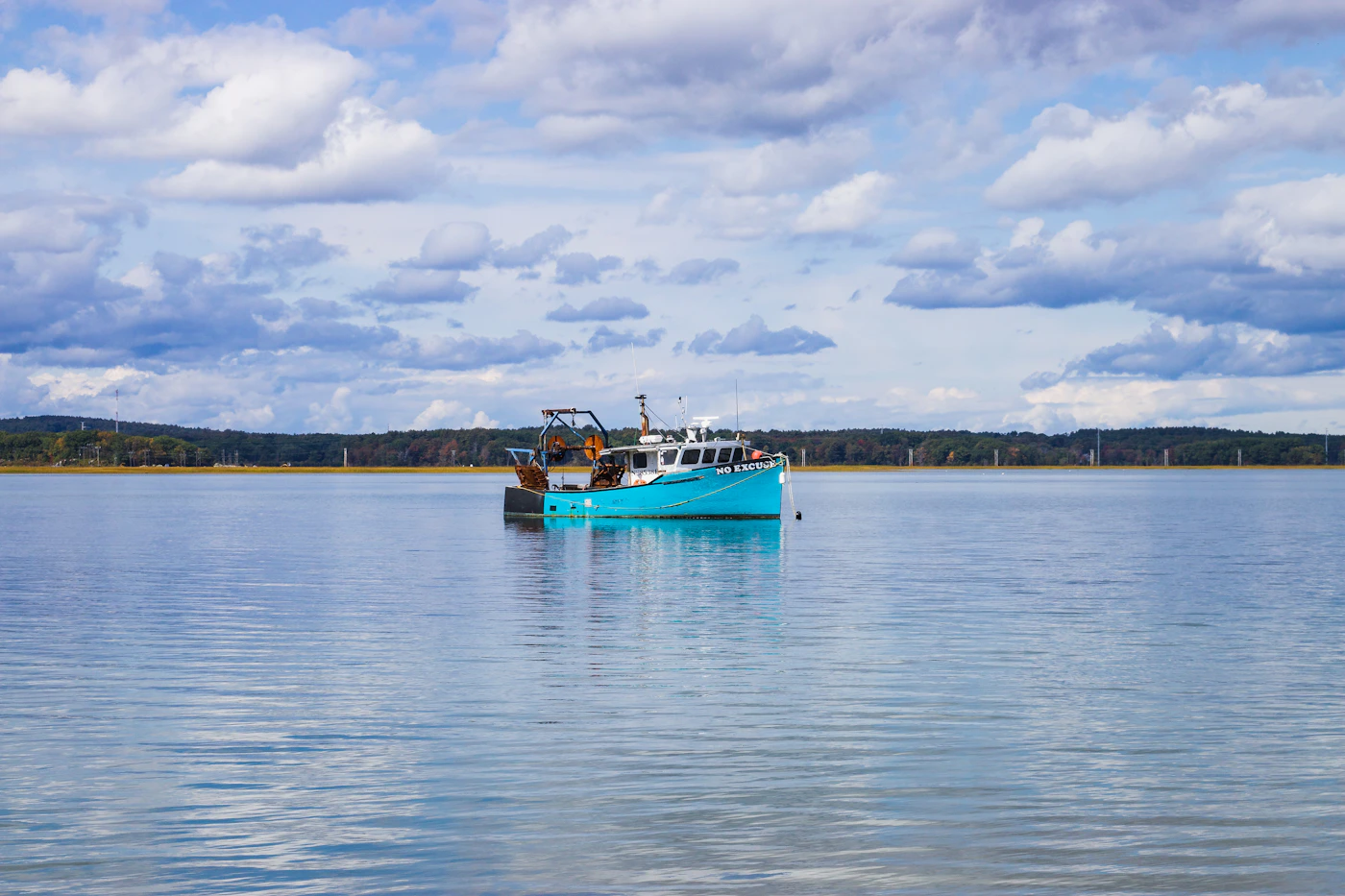 A blue and white commercial fishing boat working on open water, representing the real world facts that decide a claim's value