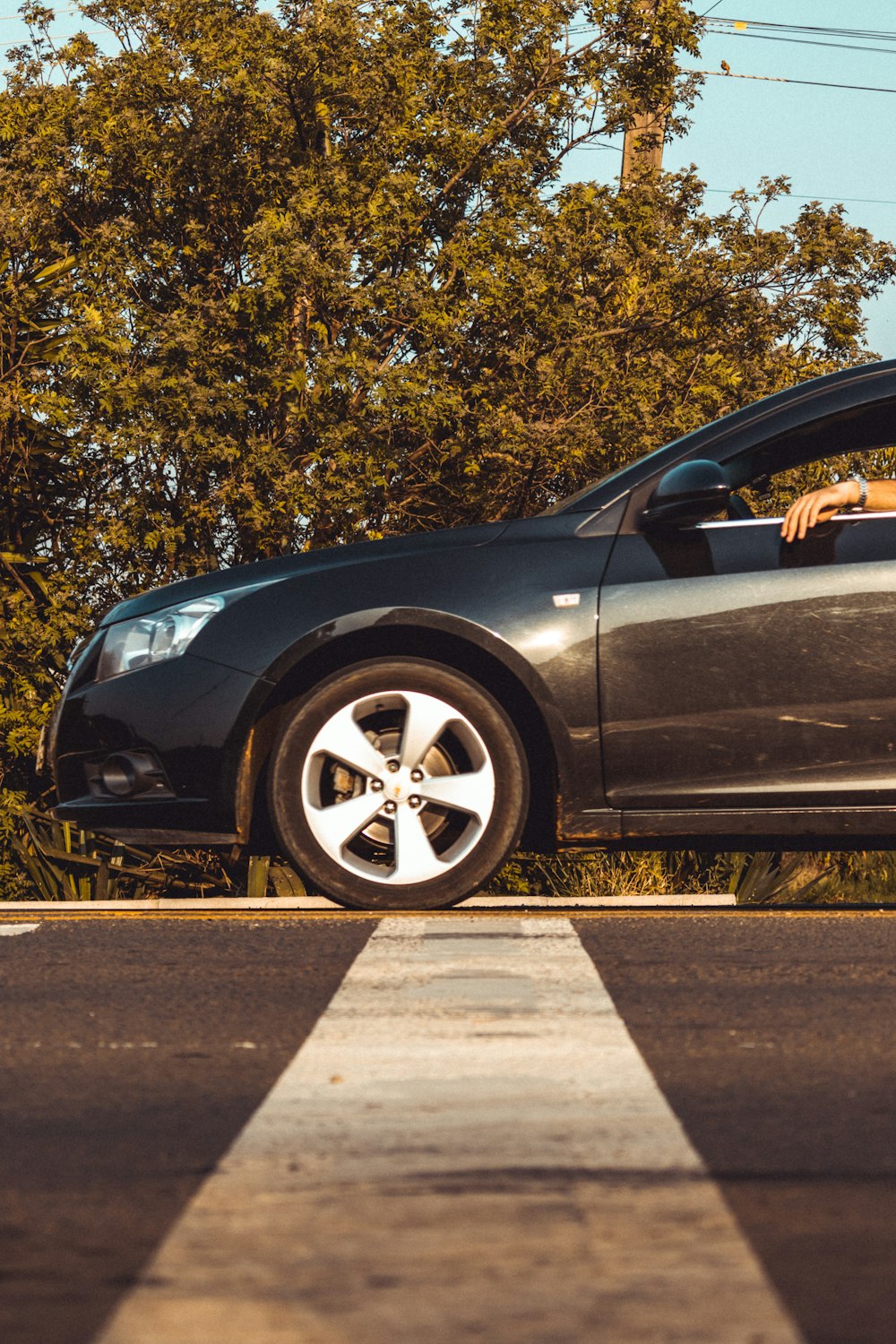 black car on gray asphalt road during daytime