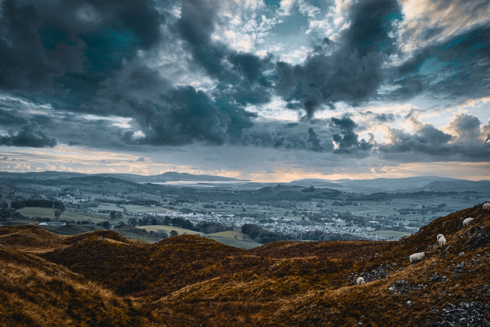 aerial view of mountains under cloudy sky during daytime