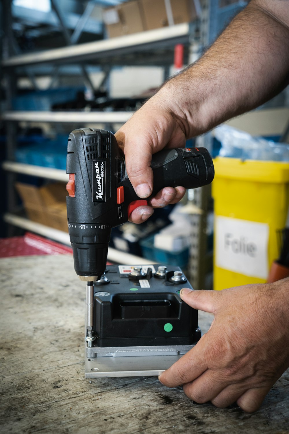 a man using a drill gun on a piece of metal