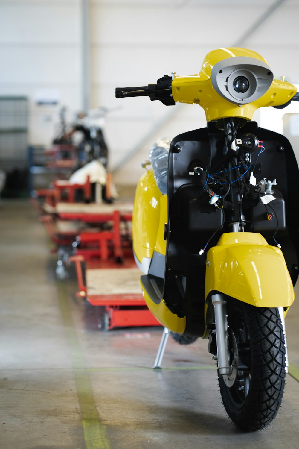 yellow and black motorcycle on gray pavement