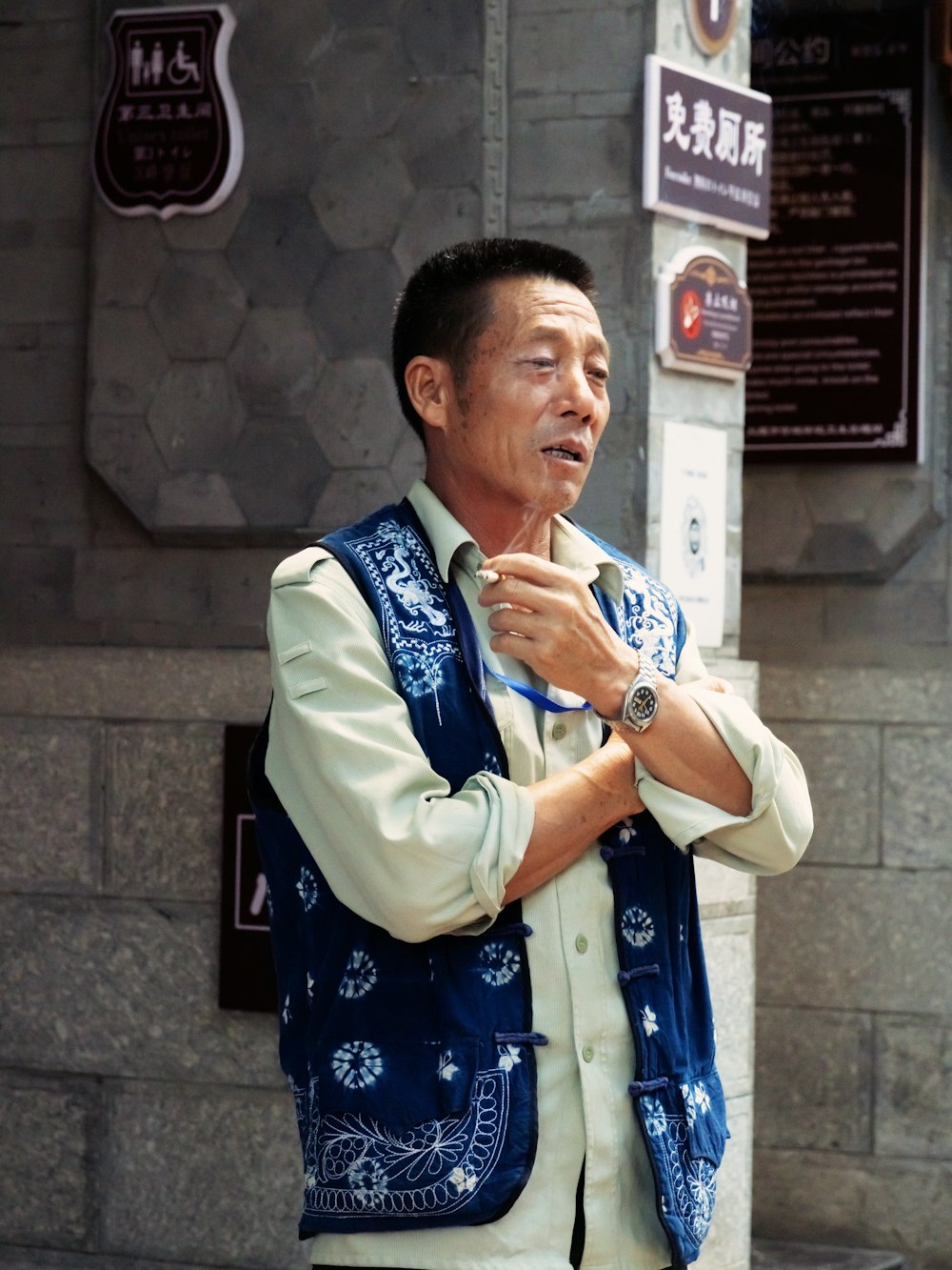 man in blue and white floral button up shirt standing beside woman in white long sleeve