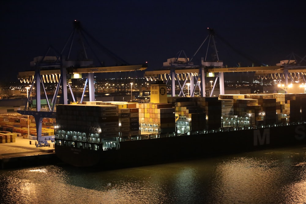 cargo ship on dock during night time