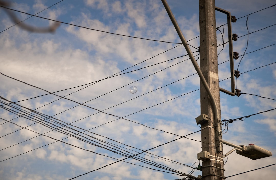 black electric wires under blue sky during daytime