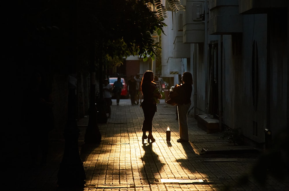 man and woman walking on sidewalk during daytime