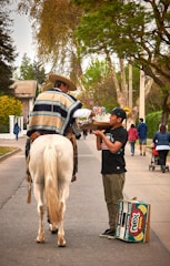 Photo of a rider carefully delivering colorful aso ebi packages to a happy vendor.