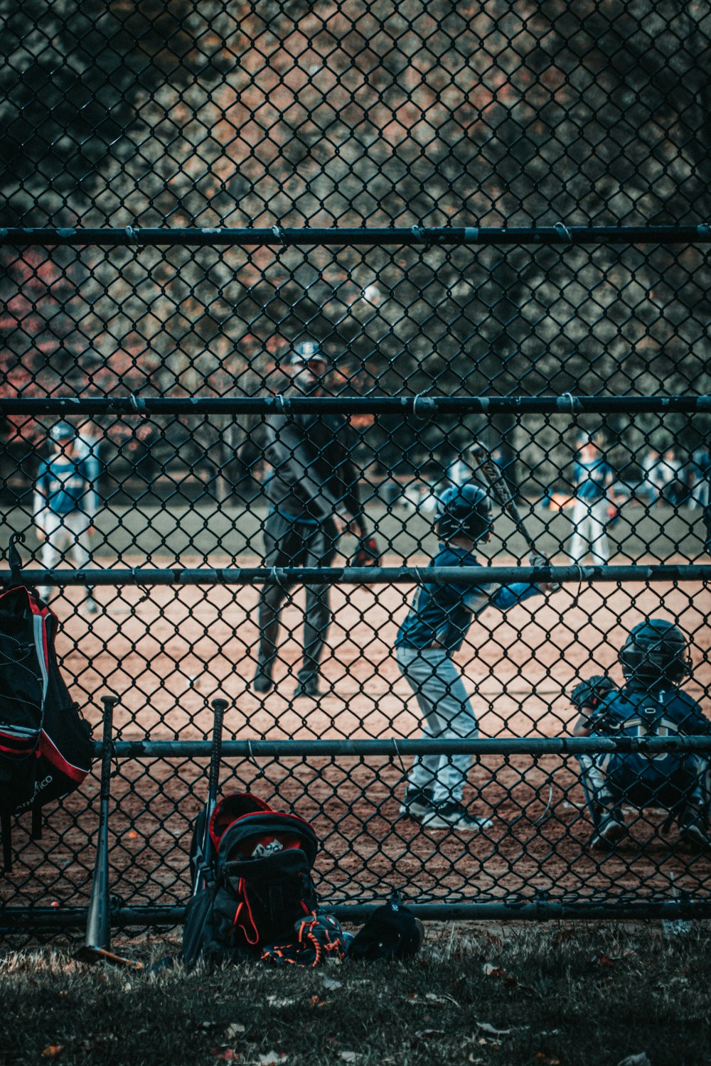 people in black and red jackets playing basketball during daytime