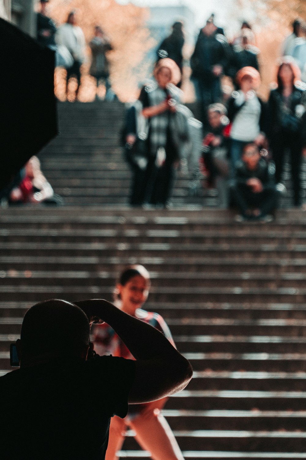 man in black suit jacket and black pants sitting on stairs