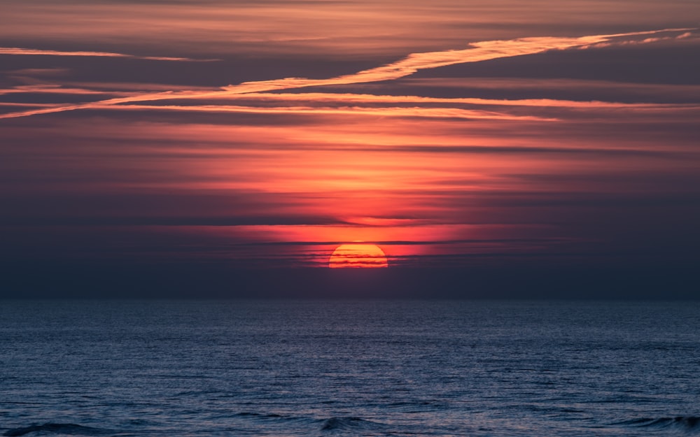 body of water during sunset