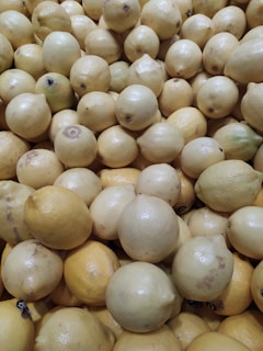 Fresh lemons piled in wooden crates ready for shipment, glowing under natural sunlight.